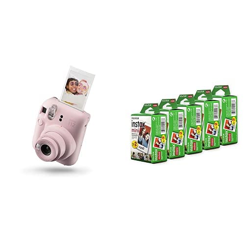 Pink Fujifilm Instax Mini 12 instant camera printing photo with five packs of instant film