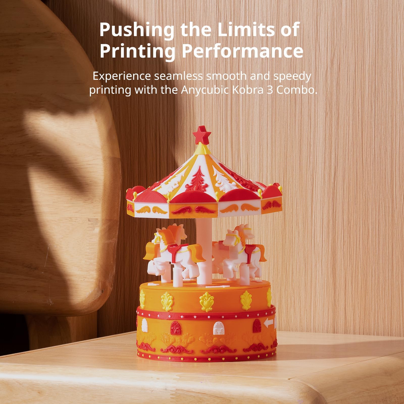 Orange and white carousel model printed with the Anycubic Kobra S1 3D printer on wooden surface