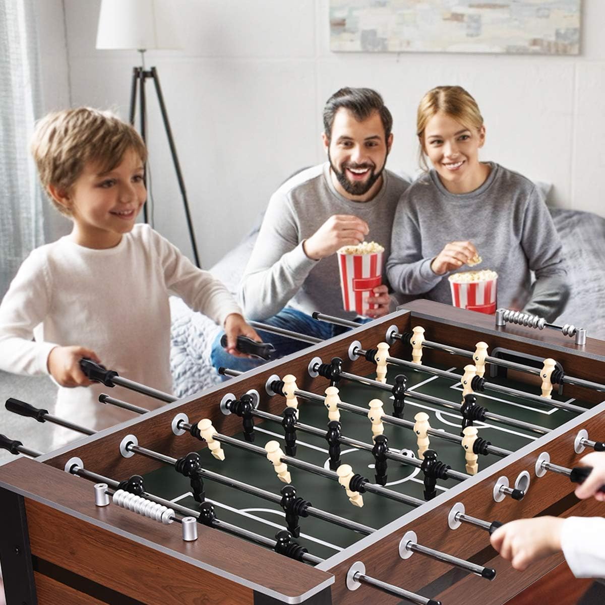 Family enjoying a game on a 54 inch foosball table by craques in a cozy living room