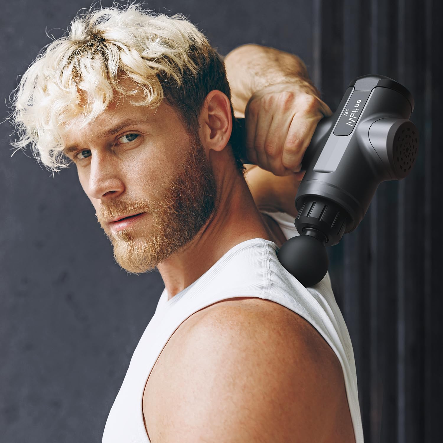 Man using craques deep tissue massage gun on shoulder for muscle relief and relaxation
