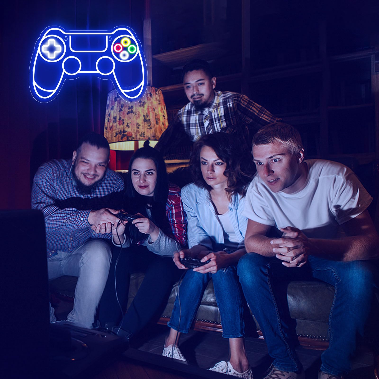 Group of friends playing video games under a blue gamer neon sign shaped like a game controller
