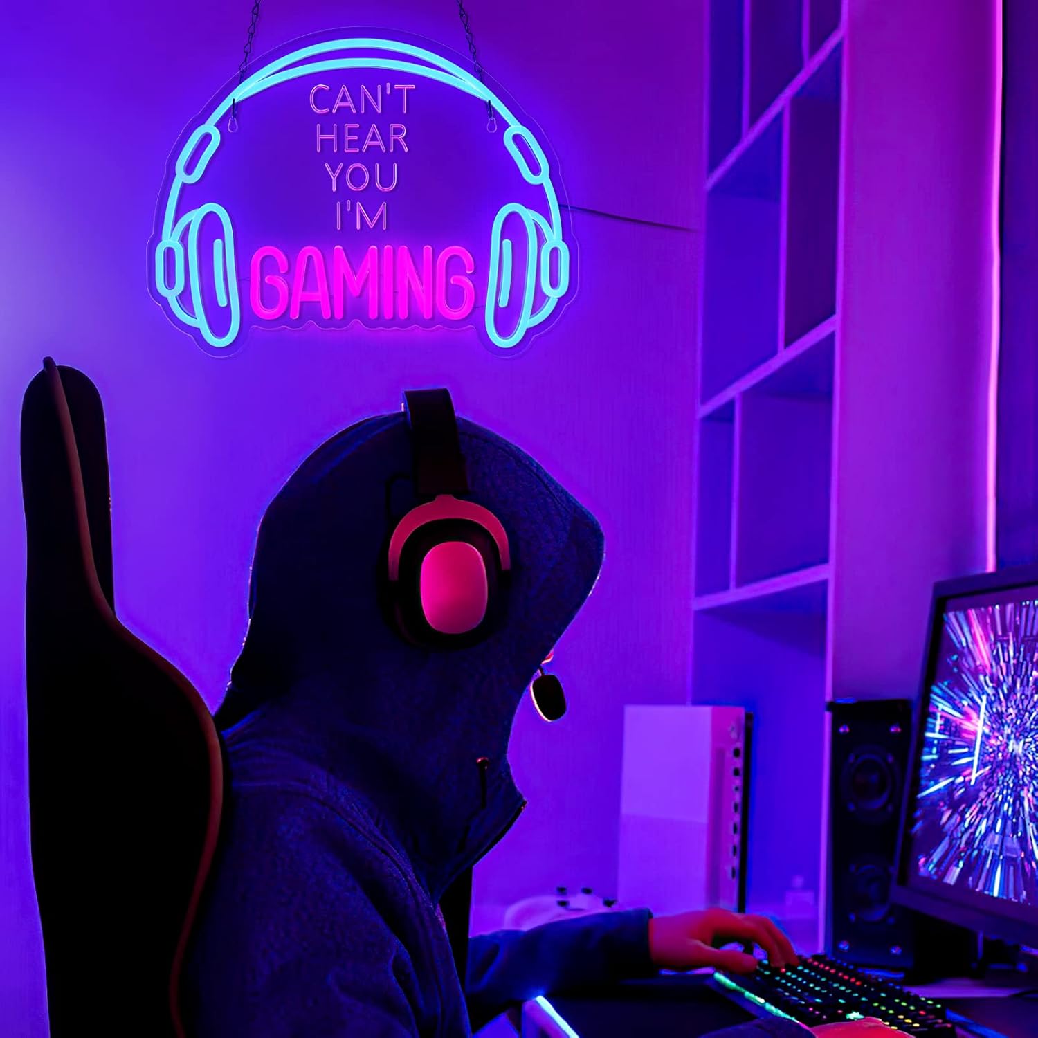 Gaming headset neon sign glowing blue and pink with gamer wearing headset in dark room setup