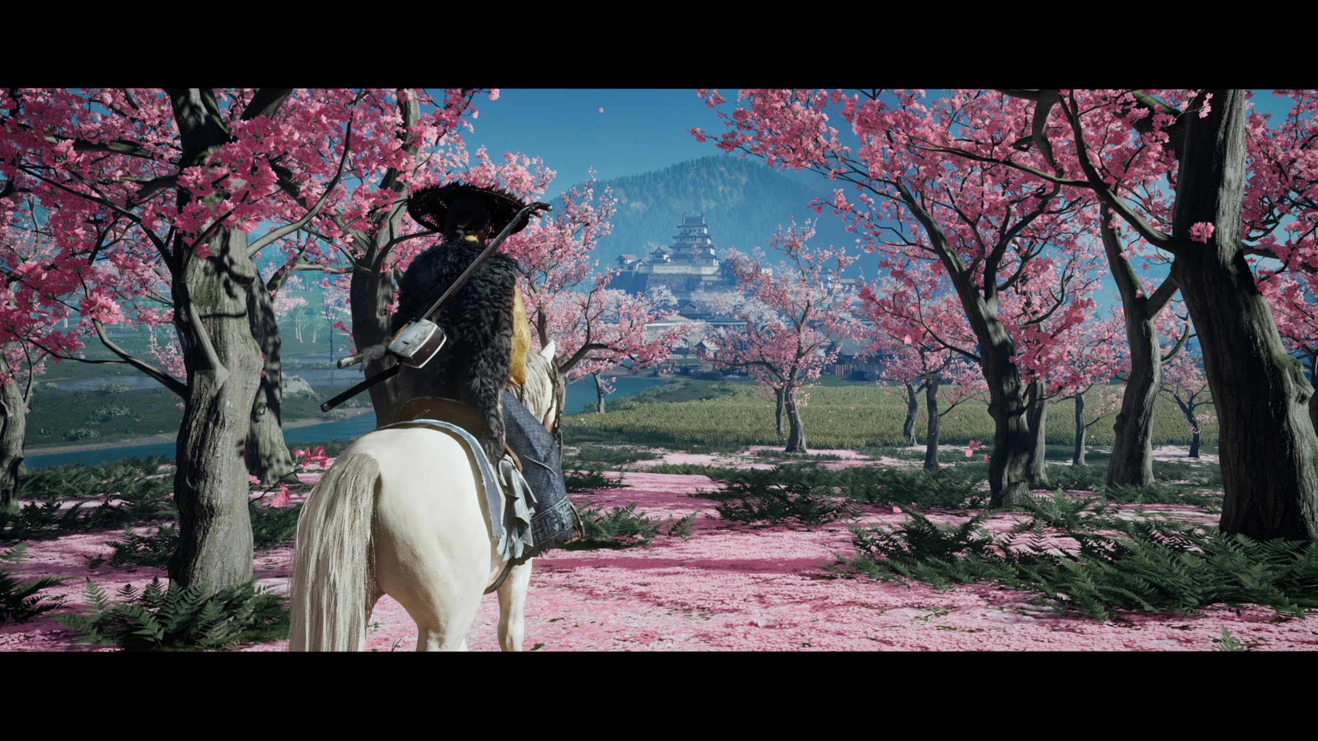 Ghost of Yōtei PS5 game scene with a character on a white horse riding through pink cherry blossom trees