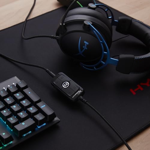 HyperX Cloud Alpha gaming headset in black with blue accents connected to gaming keyboard on desk