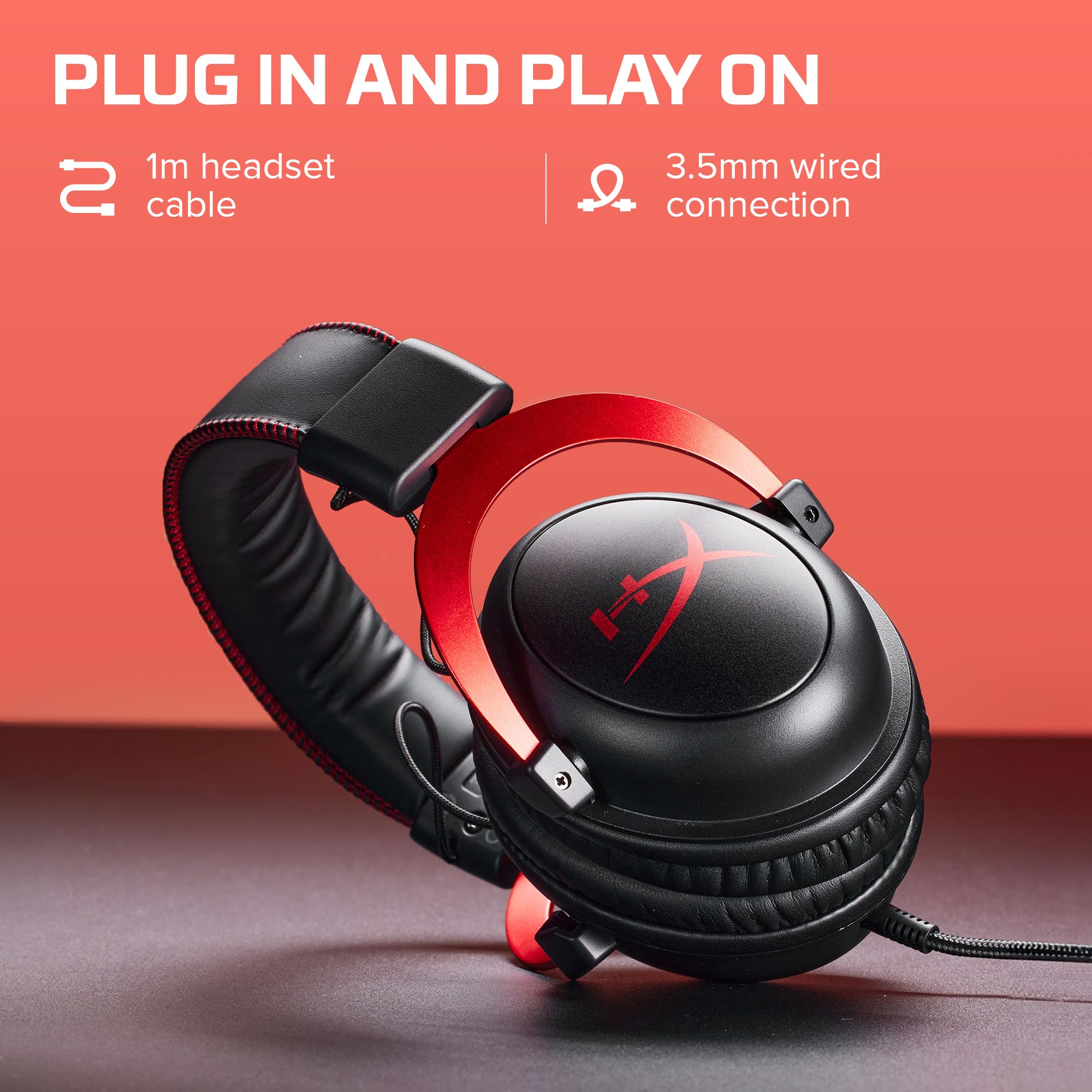 HyperX Cloud II gaming headset with red metal frame and black cushioned ear cups on a table