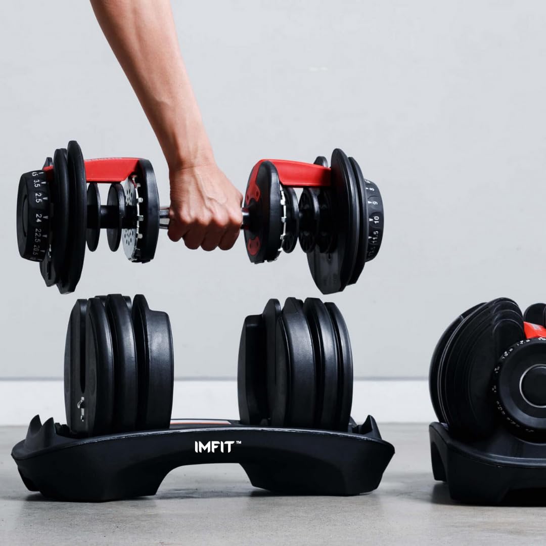 Craques adjustable dumbbells set with black weight plates and red handles held by a hand