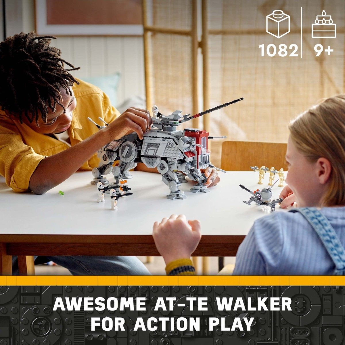 Kids playing with LEGO Star Wars AT-TE Walker set on a table with minifigures for action play