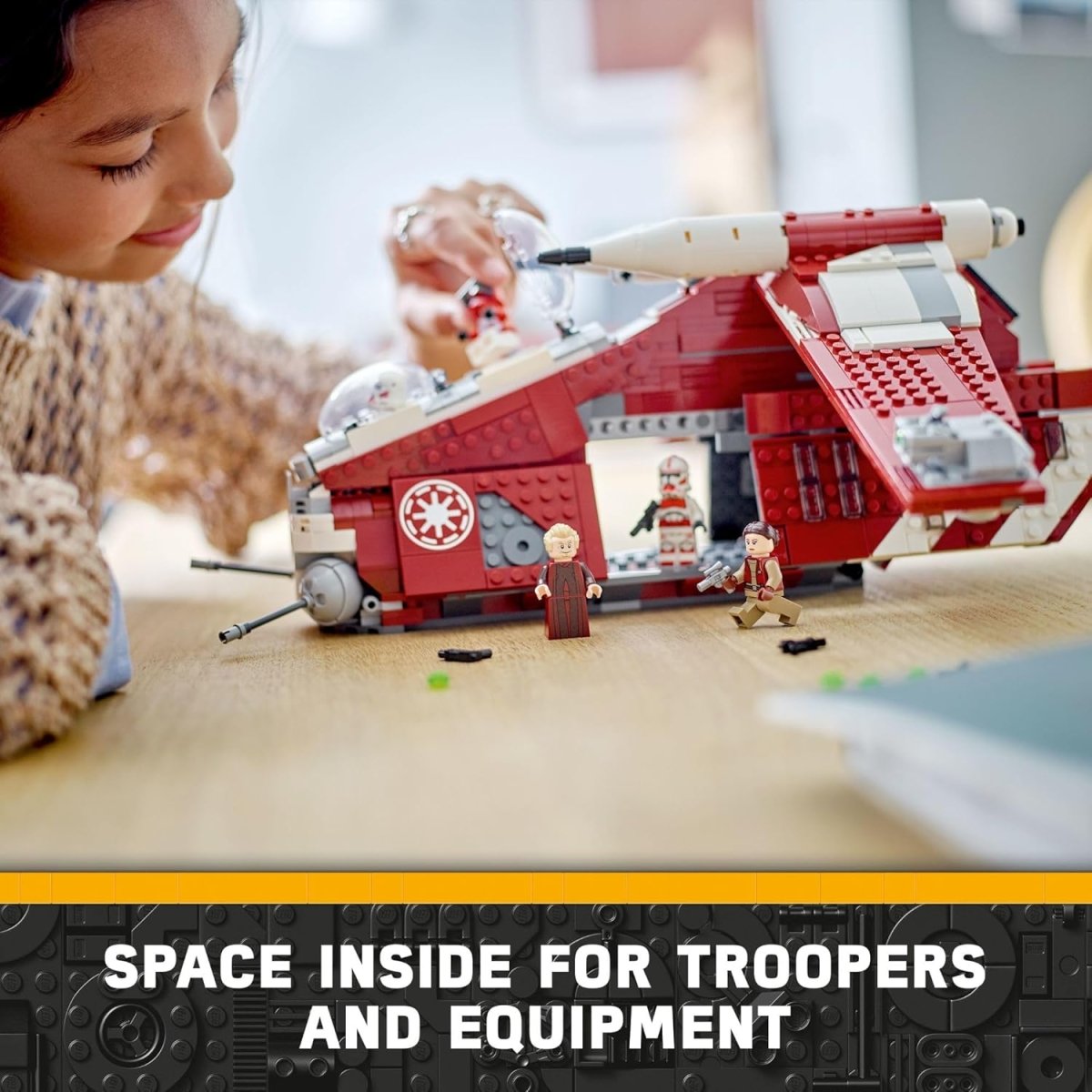 Child playing with LEGO Star Wars Coruscant Guard Gunship building set with space inside for troopers and equipment