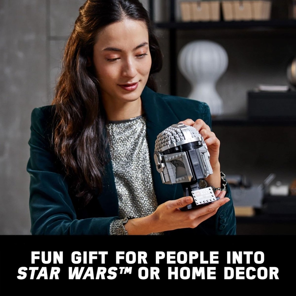 Woman holding LEGO Star Wars Mandalorian helmet model as a fun gift or home decor piece