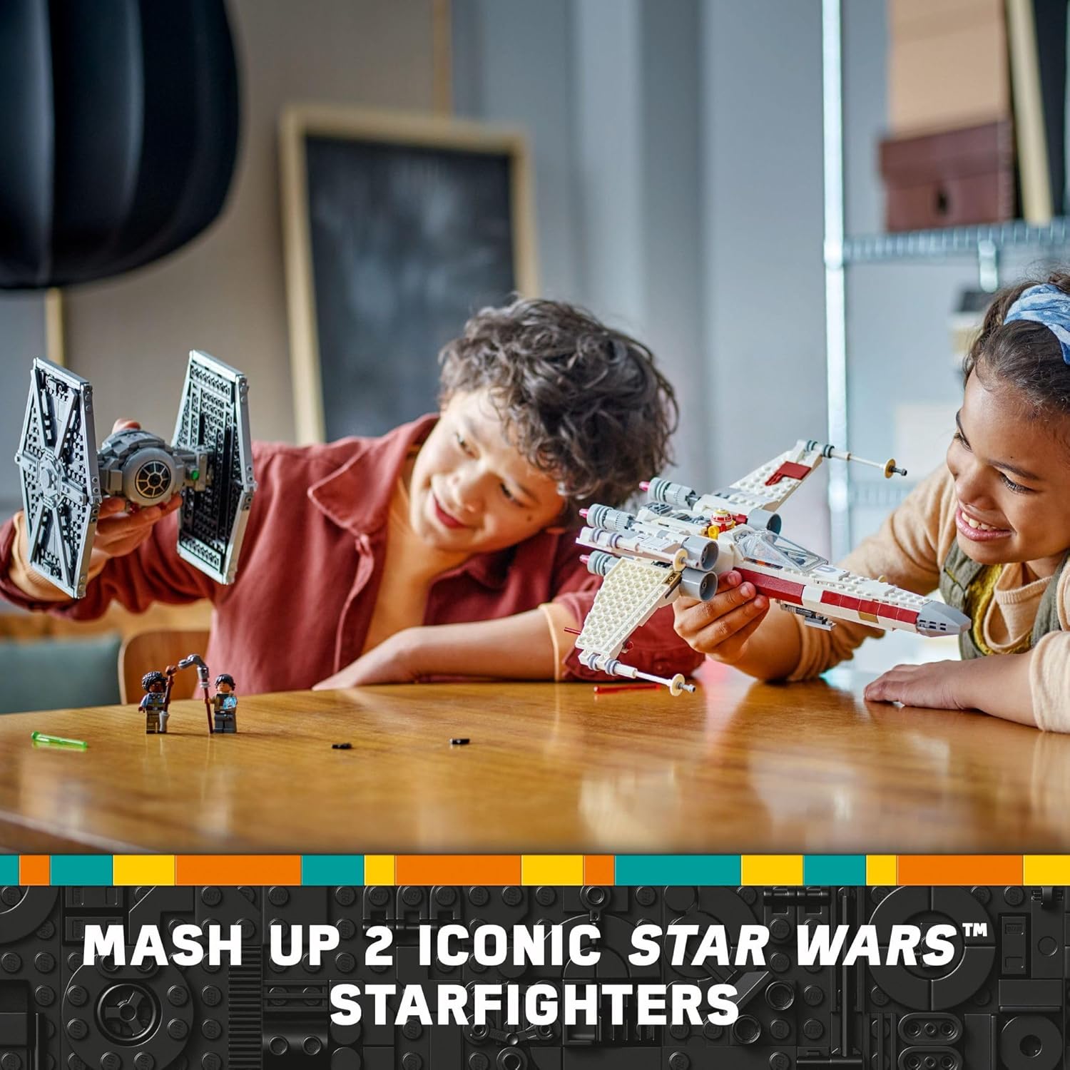Children playing with LEGO Star Wars mash-up set featuring iconic Starfighters on wooden table