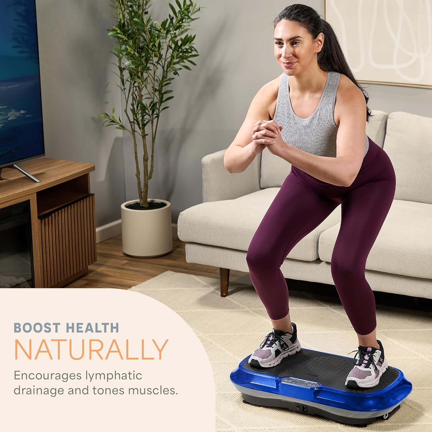 Woman using a blue vibration plate exercise machine by craques at home to boost health naturally
