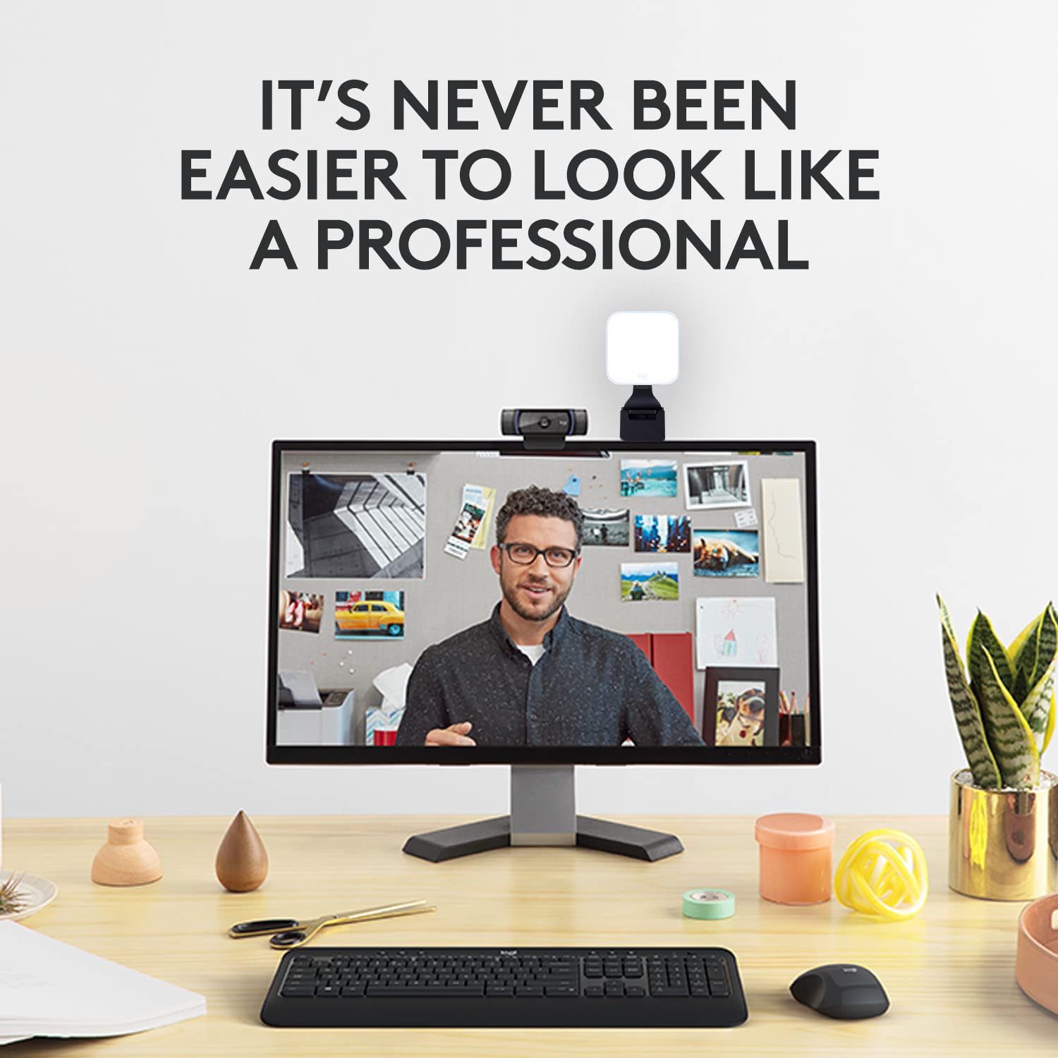 Logitech C920x HD Pro Webcam mounted on monitor with man in video call and ring light in office setup