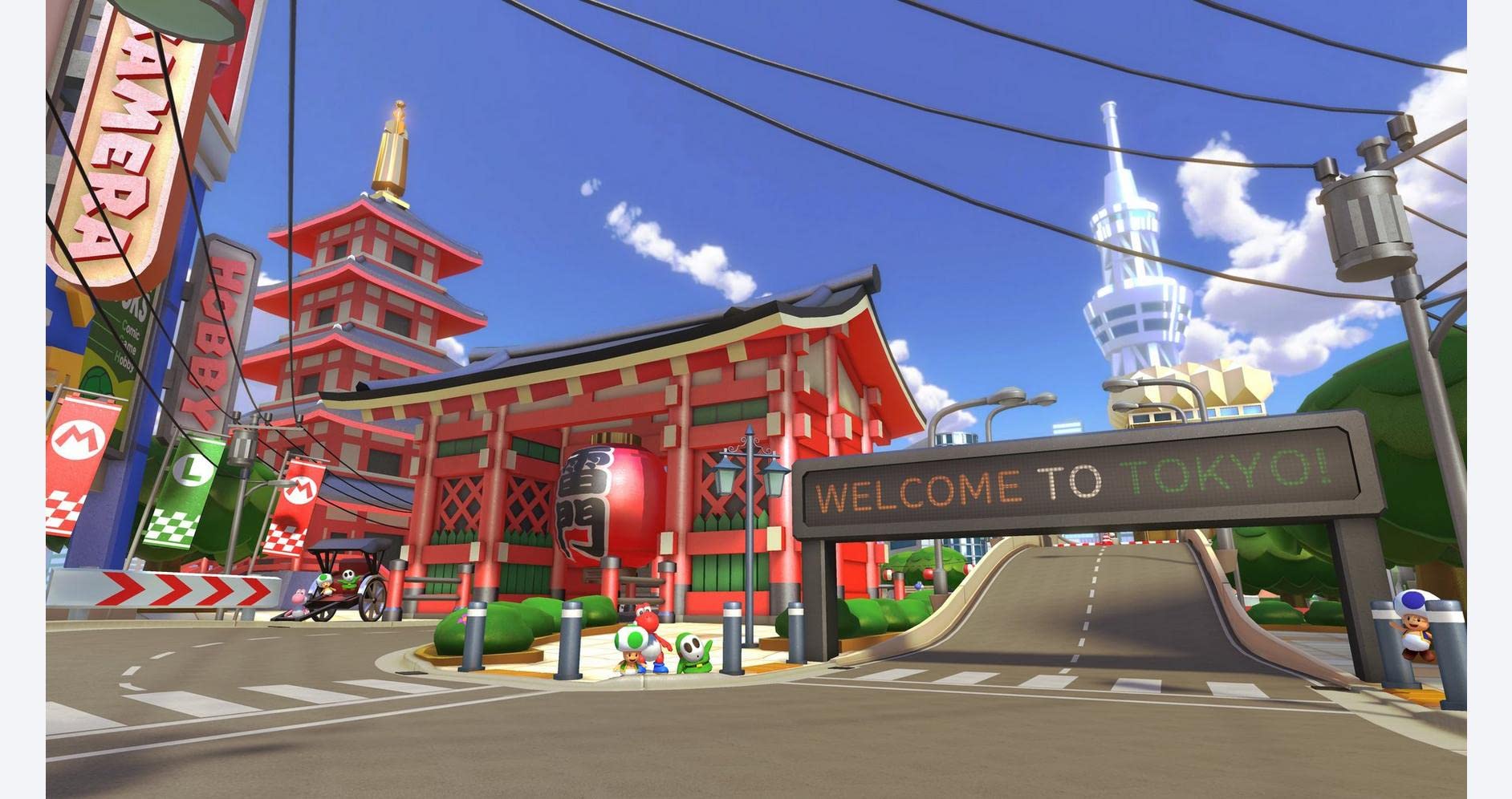 Mario Kart 8 Deluxe Nintendo Switch gameplay showing a colorful Tokyo race track with Asian-style buildings and a welcome sign