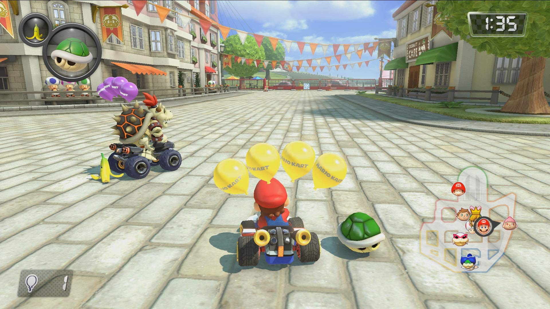 Mario Kart 8 Deluxe Nintendo Switch gameplay showing Mario racing with balloons and green shell item on a city street track