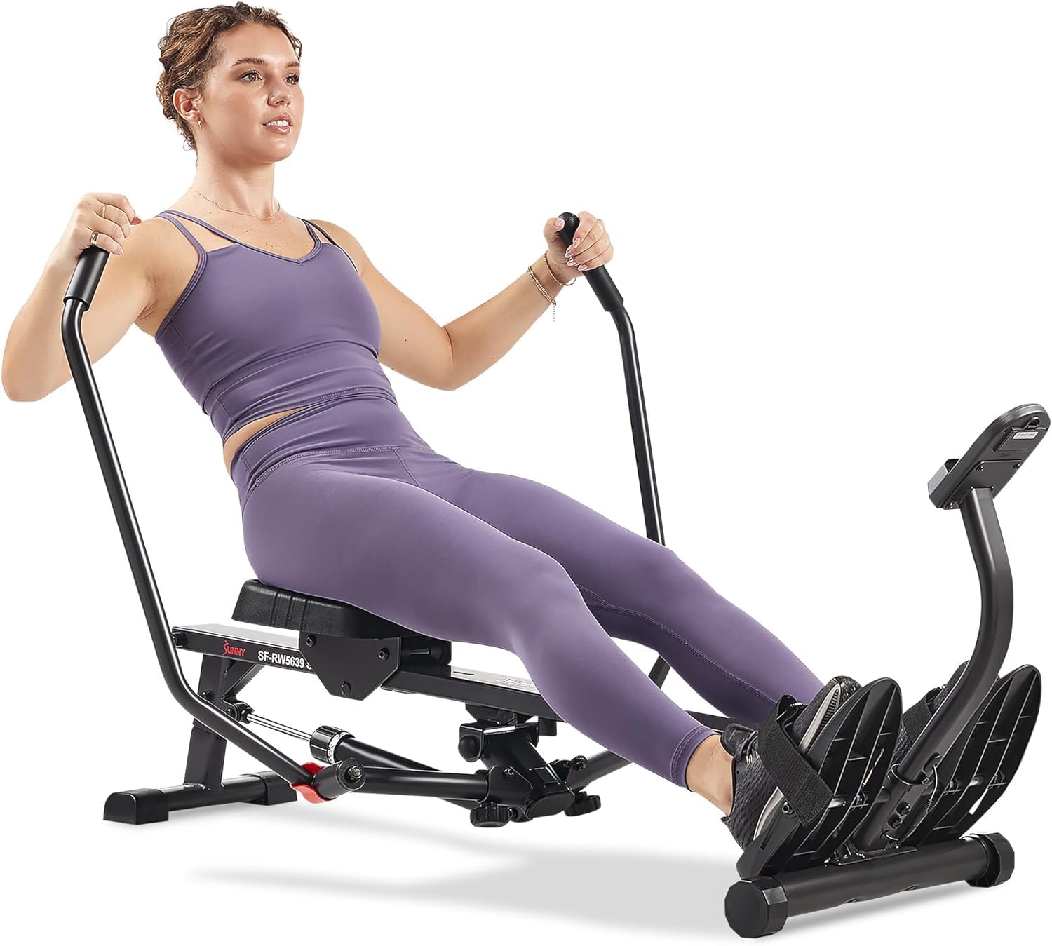 Woman using craques compact rowing machine for home gym in purple workout attire
