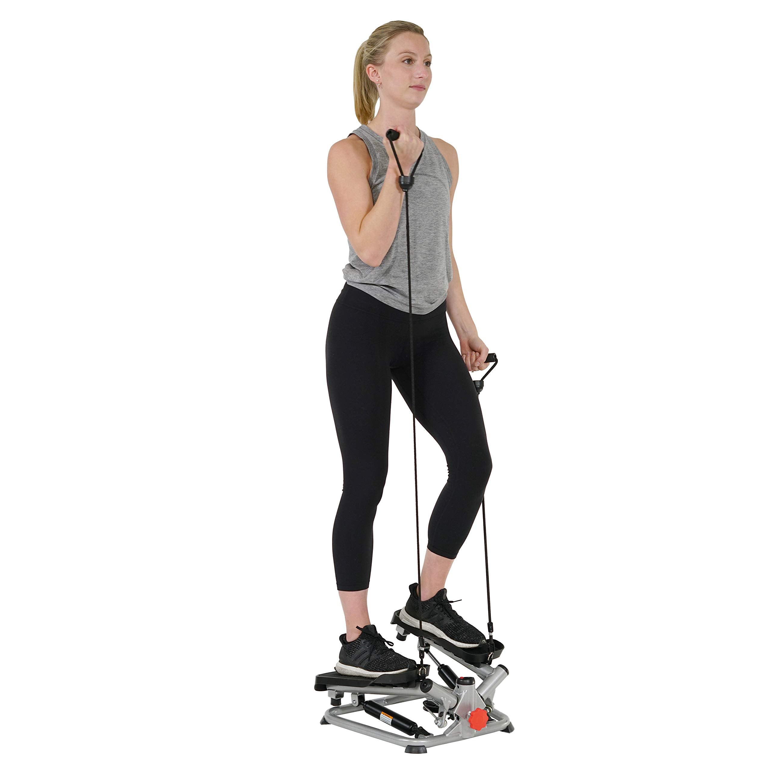 Woman using craques mini stepper for home use with resistance bands for full body workout