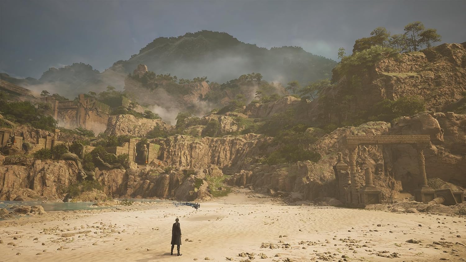 Lost Soul Aside PS5 game scene showing a character standing in a vast desert landscape with rocky cliffs and misty mountains