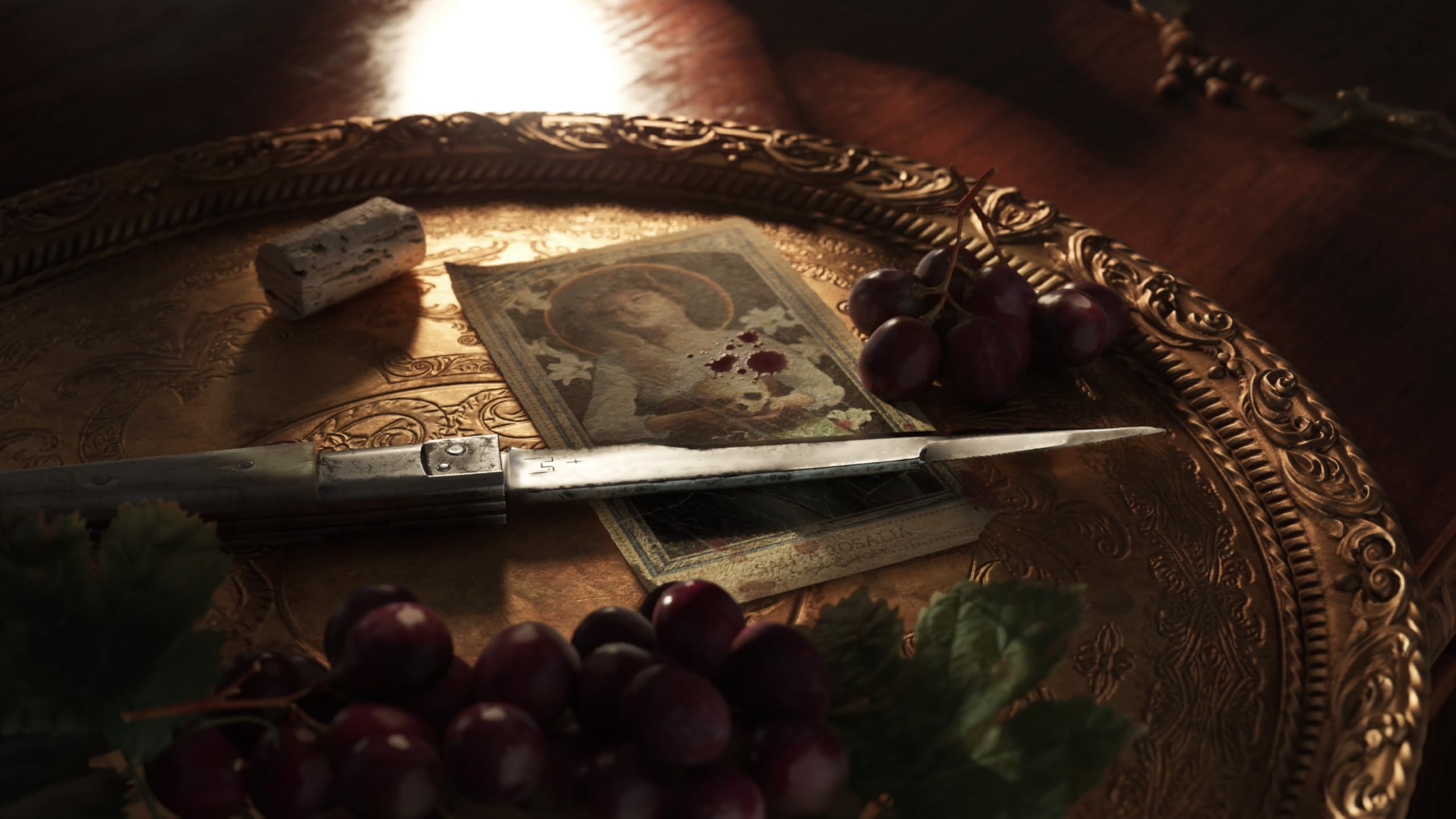 Close-up of a vintage photo, knife, and grapes on an ornate brass tray for Mafia The Old Country PS5