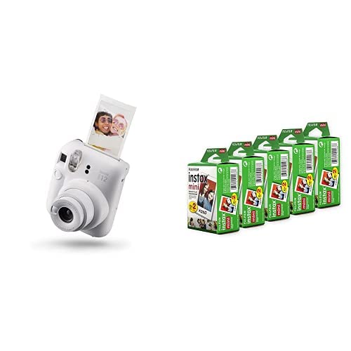 White Fujifilm Instax Mini 12 instant camera printing a photo next to five packs of instant film cartridges