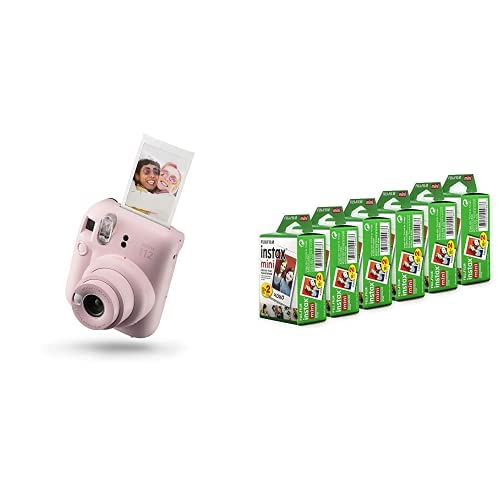 Pink Fujifilm Instax Mini 12 instant camera with developed photo and six packs of Fujifilm instant film