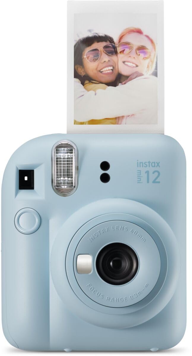 Light blue Fujifilm Instax Mini 12 instant camera printing a photo of two smiling friends