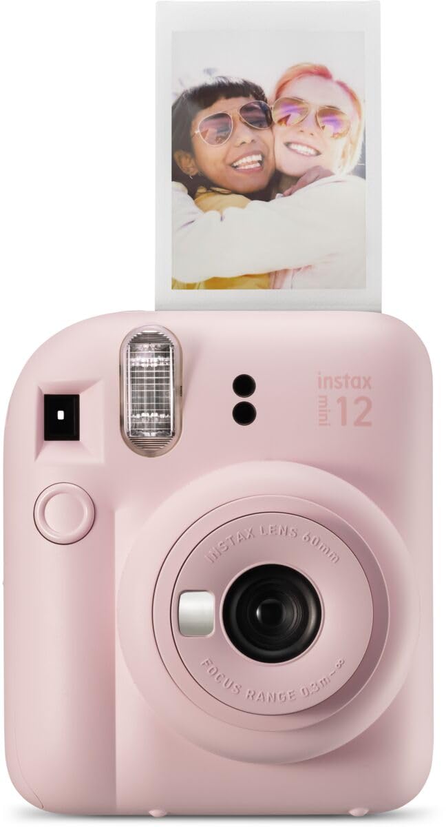 Pink Fujifilm Instax Mini 12 instant camera with a developed photo of two smiling women