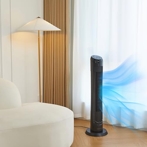 Craques oscillating tower fan with remote in black placed in a living room near a window and sofa