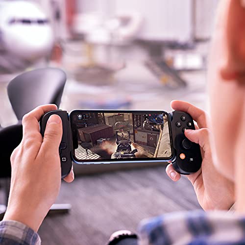 Person playing first-person shooter game on smartphone with BACKBONE One controller for Android in hands
