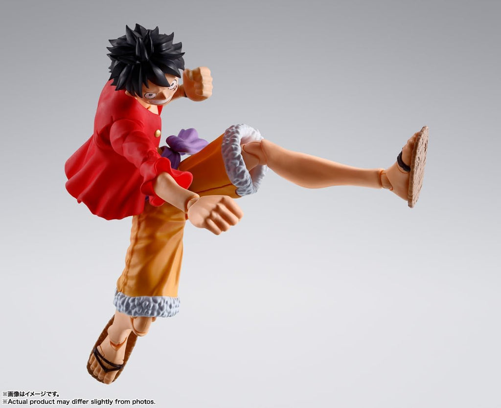 Monkey D. Luffy action figure by craques in dynamic kicking pose wearing red jacket and orange shorts