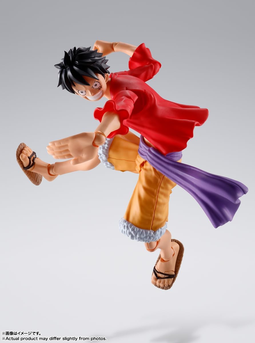 Monkey D. Luffy action figure by craques in dynamic pose wearing red shirt, yellow shorts, and purple sash