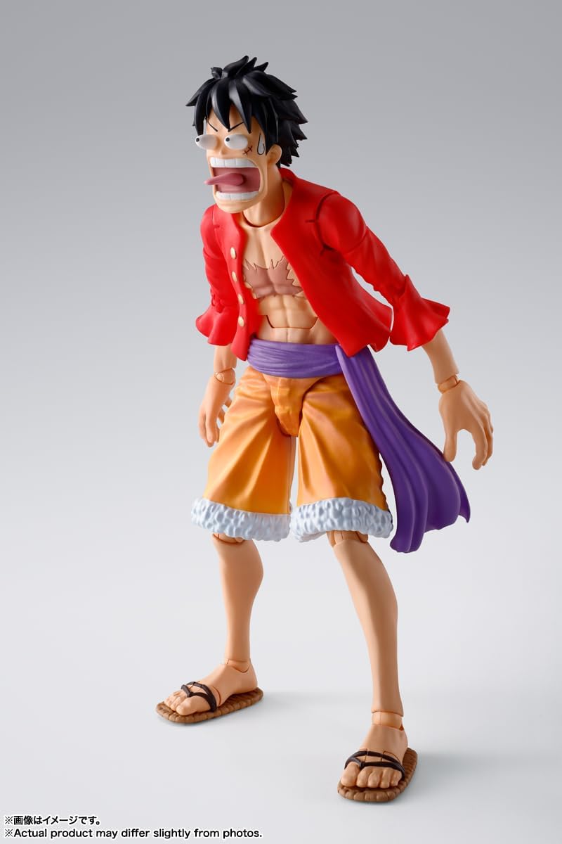 Monkey D. Luffy action figure by craques wearing red open shirt and orange shorts with purple sash