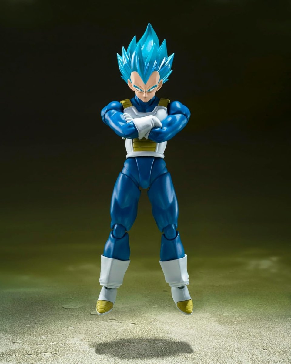 Super Saiyan God Vegeta action figure in blue armor with crossed arms floating on a gray surface