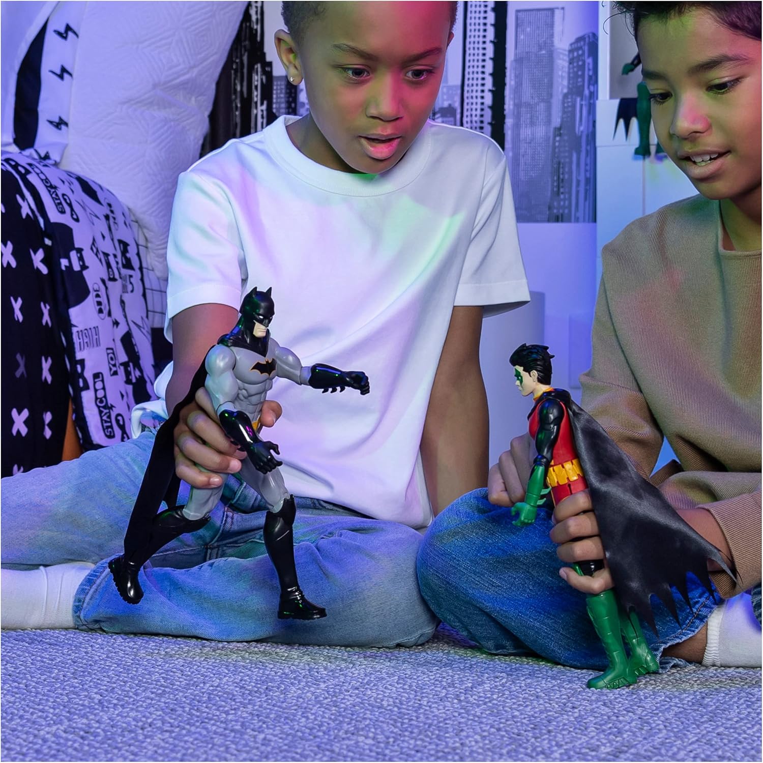 Two kids playing with Batman 12 inch action figure set featuring Batman and Robin characters indoors