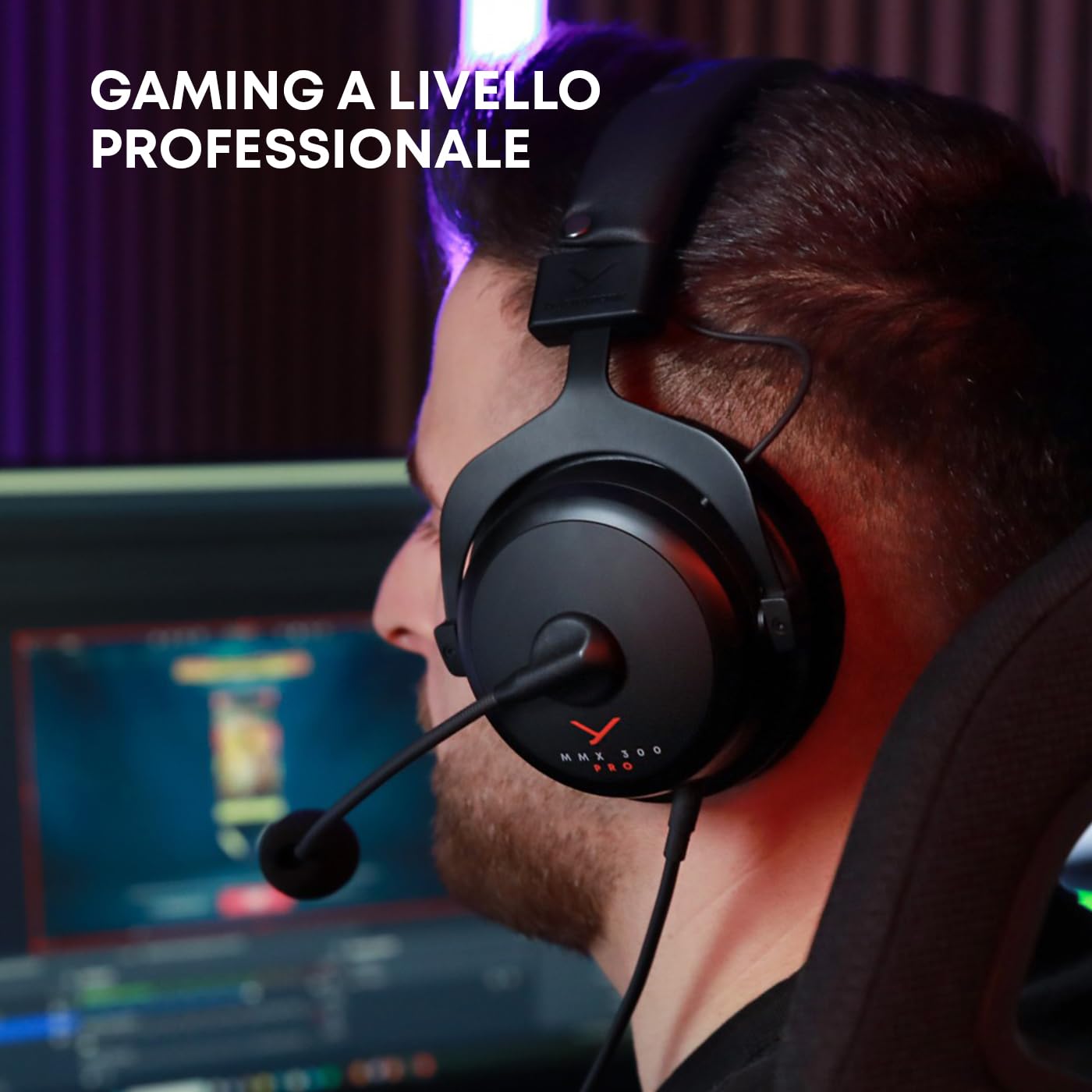 Gamer wearing beyerdynamic MMX 300 PRO gaming headset with microphone in front of computer screens