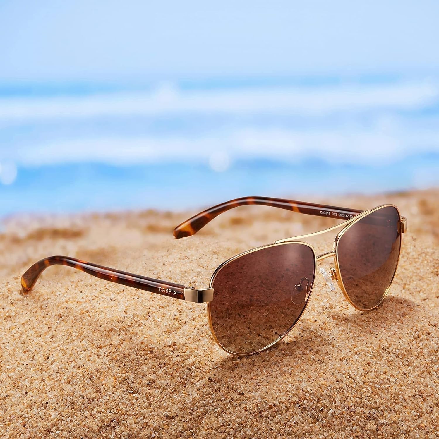 Craques polarized sunglasses for women with gold frame and brown lenses on sandy beach
