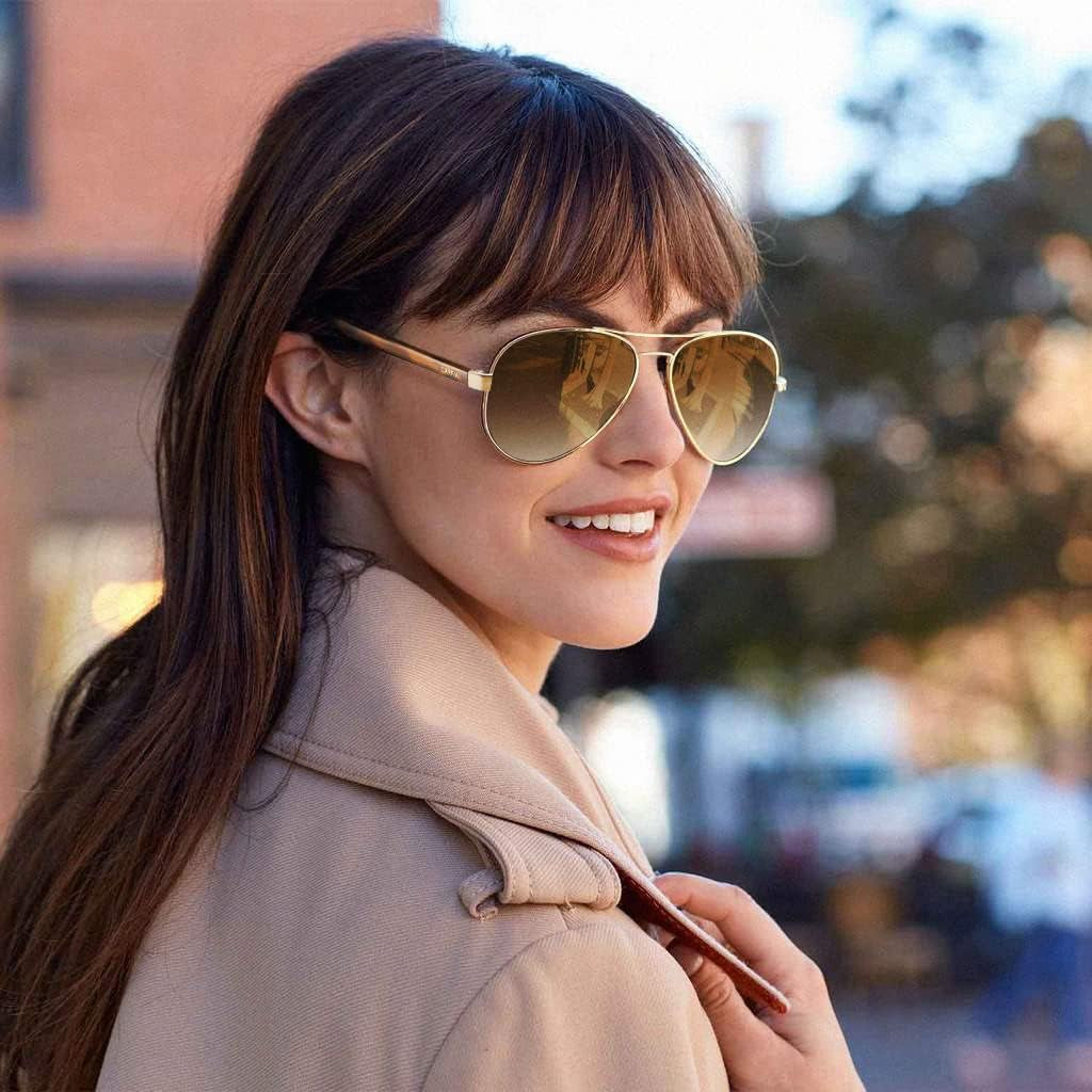 Woman wearing craques polarized sunglasses for women with gold frames outdoors