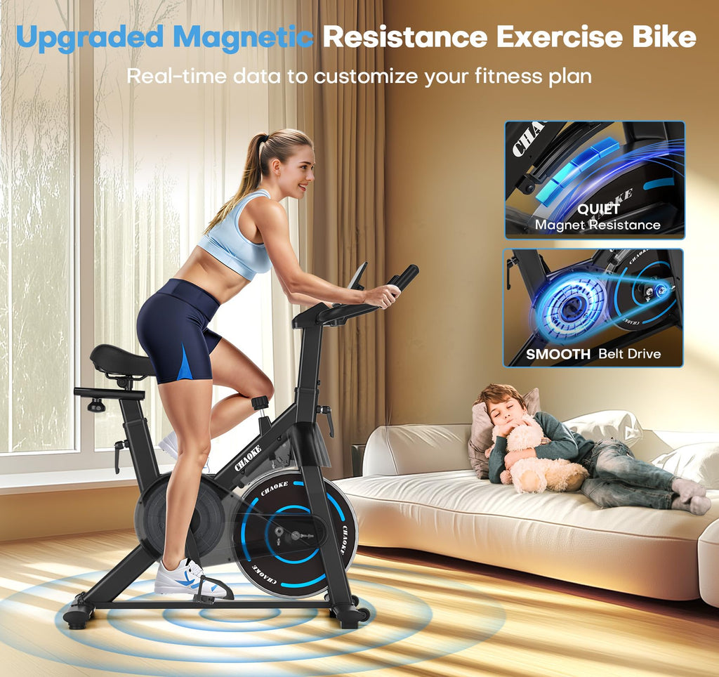 Woman using craques magnetic resistance exercise bike in bright living room with child resting on couch