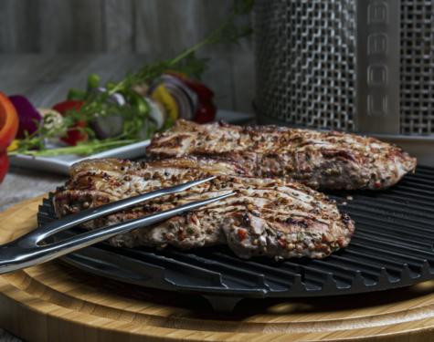 Cobb Premier Pro Griddle replacement with grilled steaks and vegetables on a wooden surface