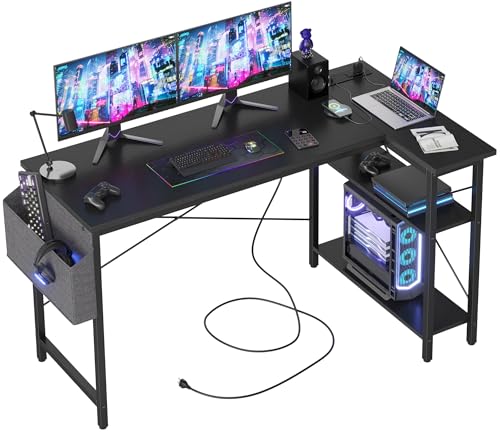 Craques computer desk with power outlets featuring triple monitors setup laptop and gaming accessories
