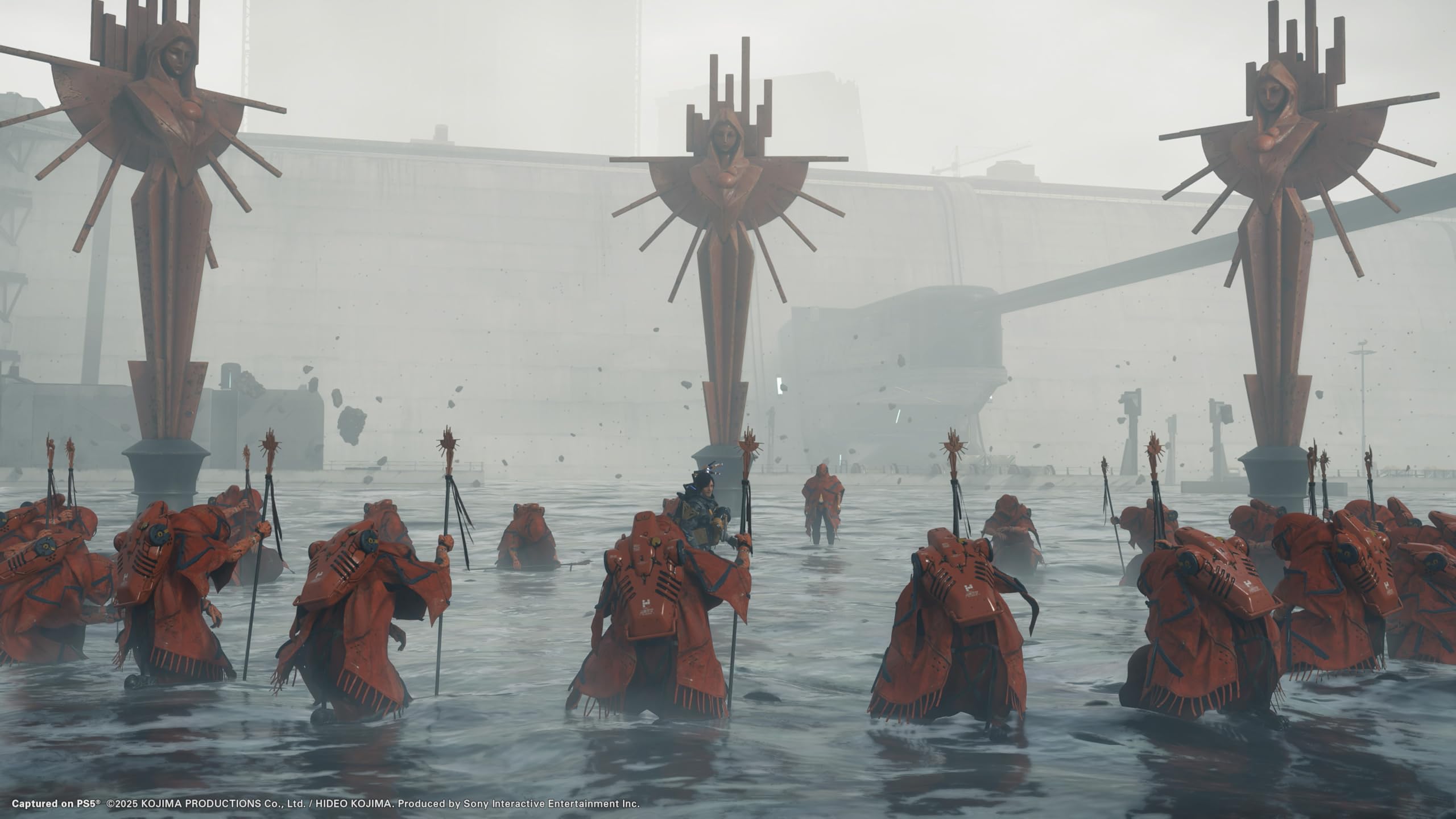 Death Stranding 2 Collector's Edition PS5 scene with multiple hooded figures standing in water holding staffs