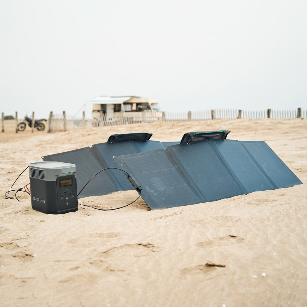 Craques portable solar generator kit with foldable solar panels and power station set up on sandy beach
