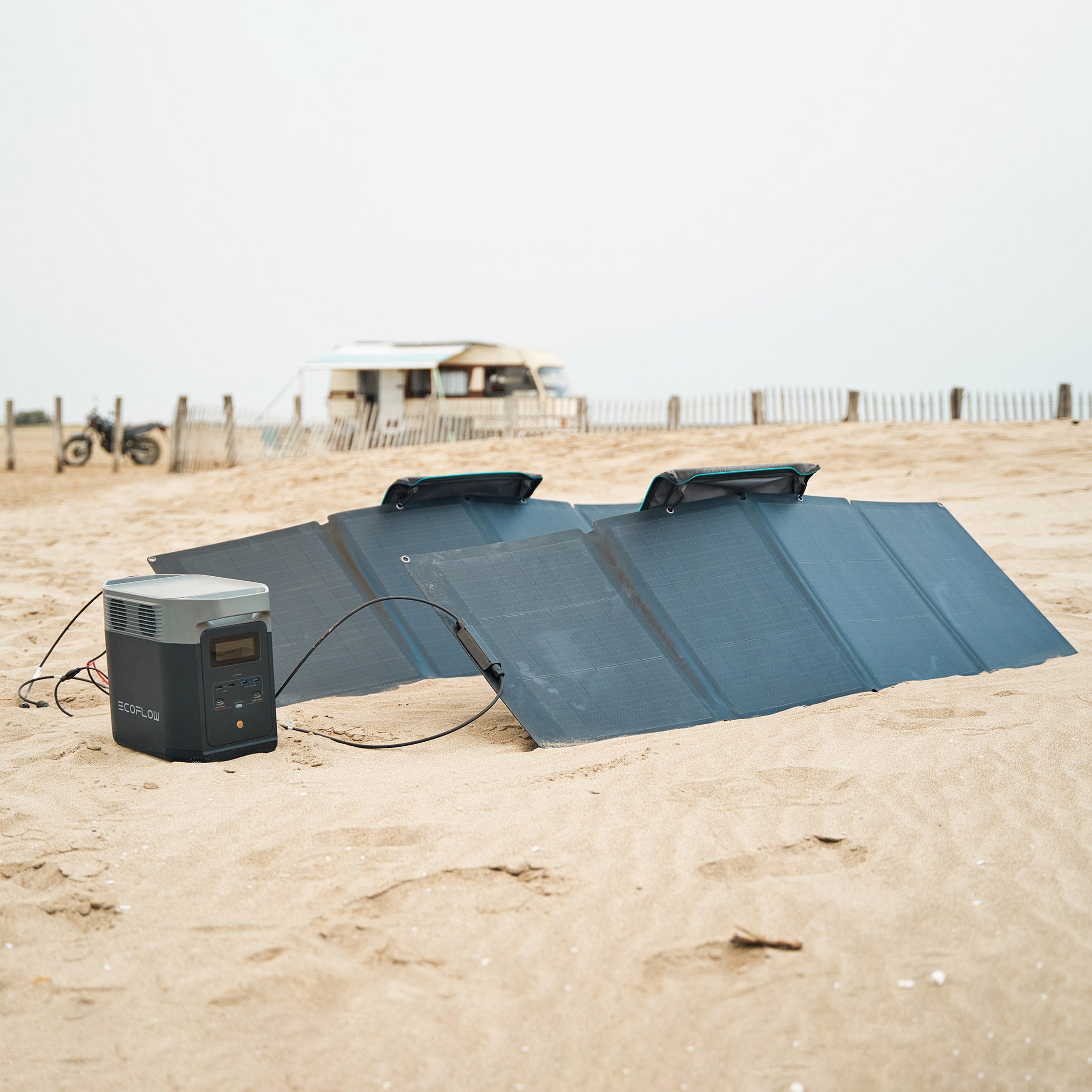 Craques portable solar generator kit with foldable solar panels and power station set up on sandy beach