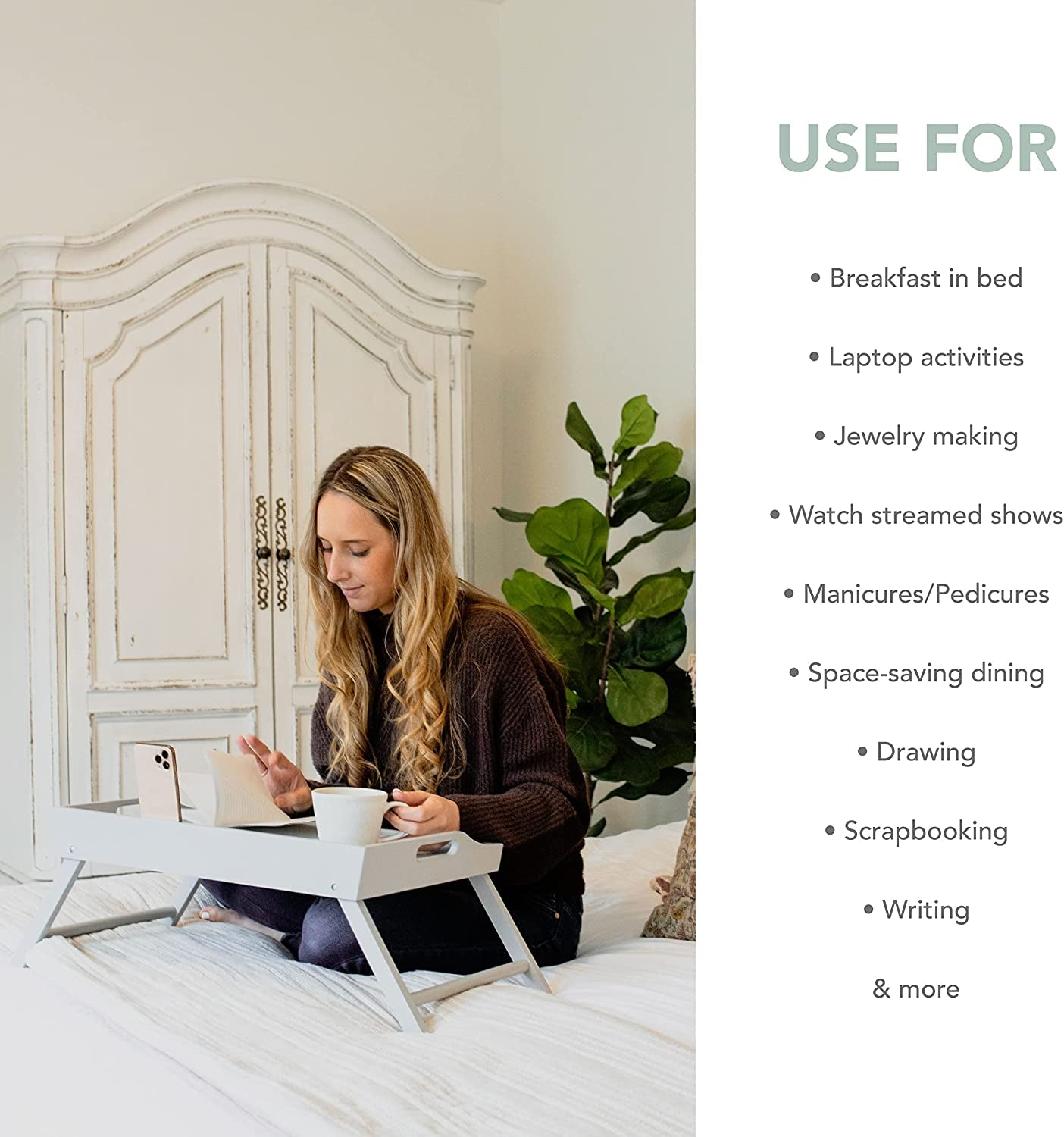 Woman using an extra large wood bed tray for laptop and breakfast in bed with white furniture background