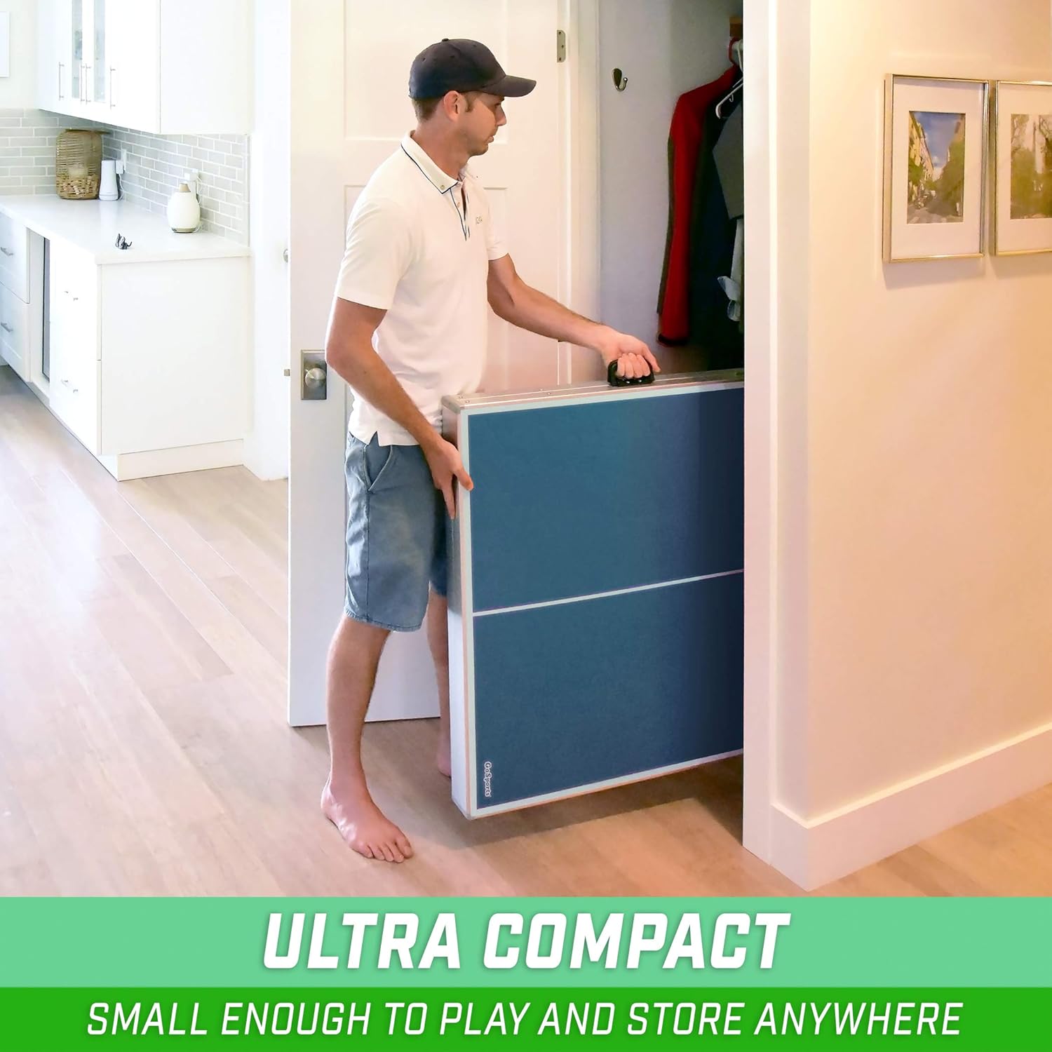 Man carrying a craques portable table tennis set folded for easy storage and transport