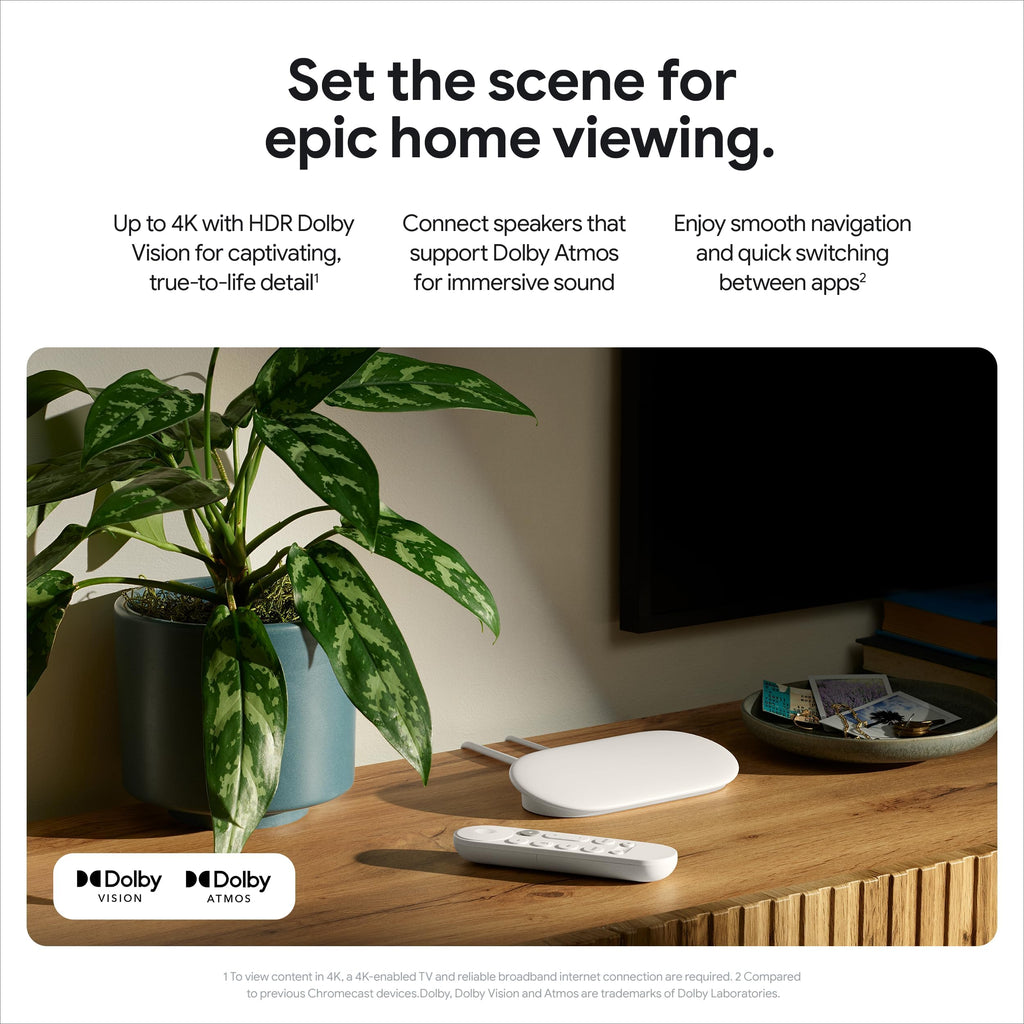 Craques 4K Google TV streaming device with remote on wooden table beside plant and mounted TV