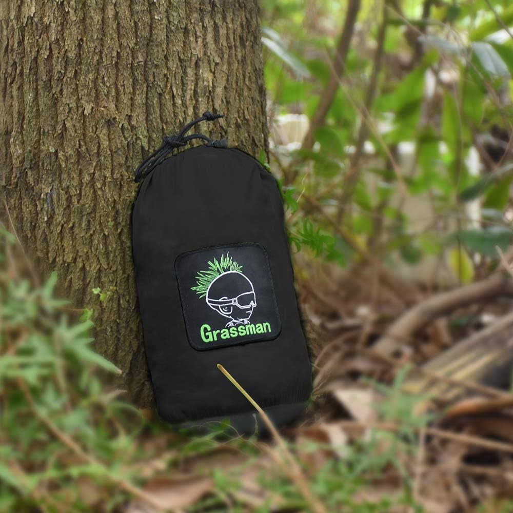 Craques double camping hammock with straps packed in a compact black carrying bag leaning against a tree