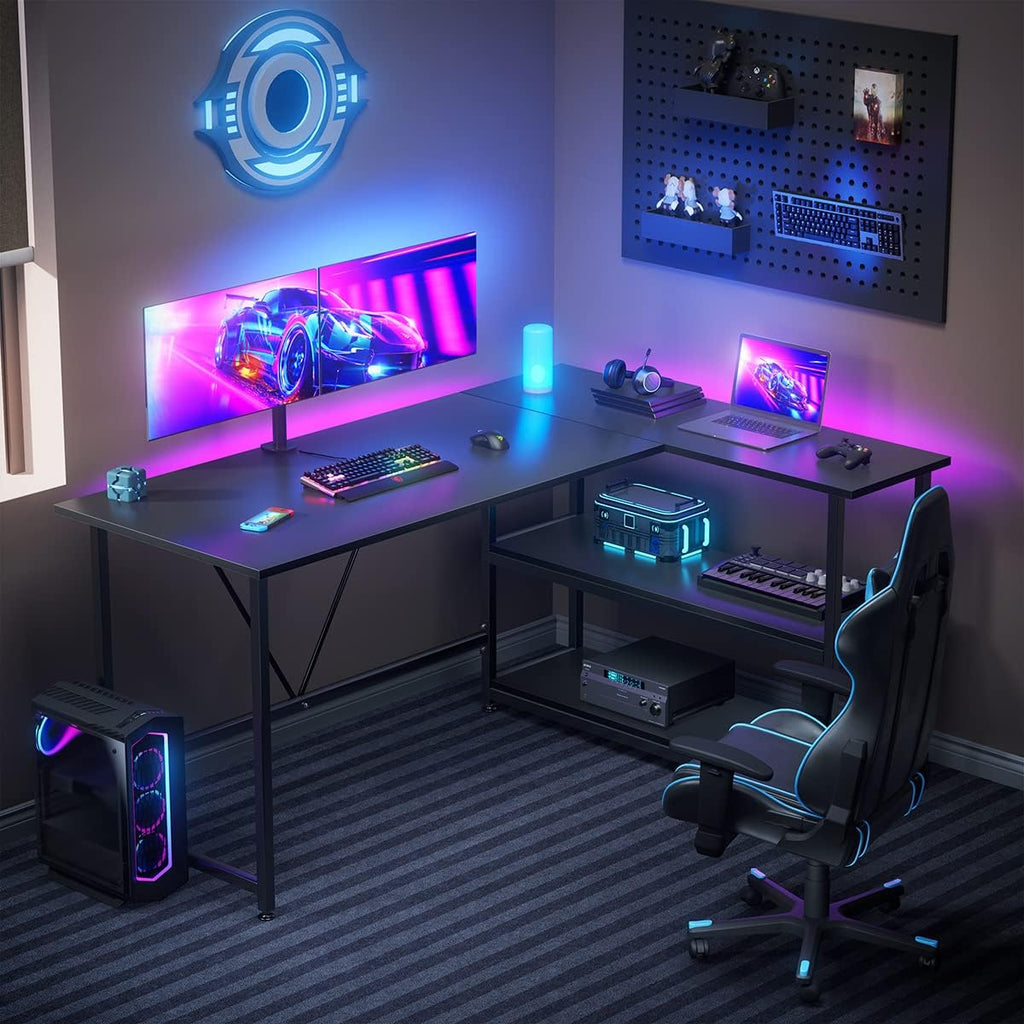L shaped gaming desk with shelves in black setup with dual monitors RGB lighting and gaming accessories