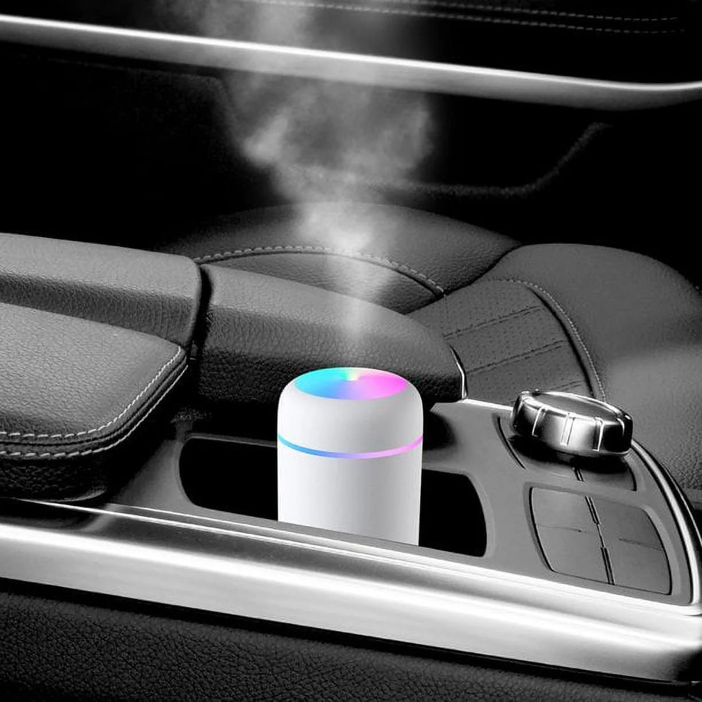 Craques portable mini humidifier emitting mist inside a car cup holder with LED light