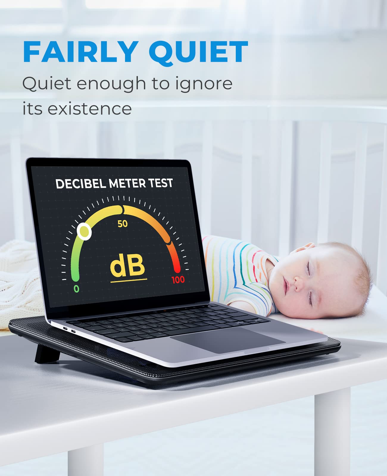 Havit laptop cooling pad supporting a laptop with a decibel meter test showing low noise level near a sleeping baby