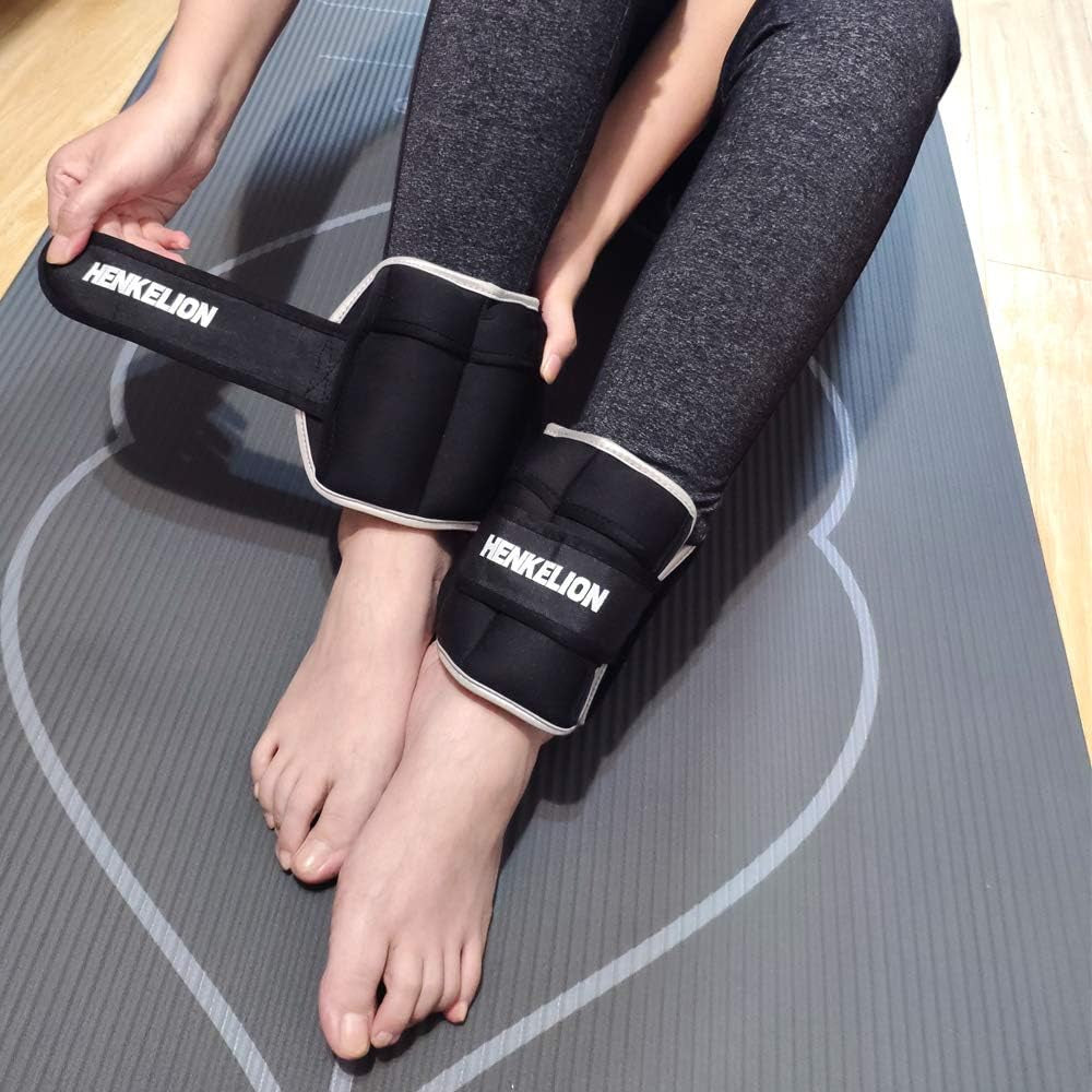 Person wearing adjustable ankle weights for workout on gray exercise mat with black leggings
